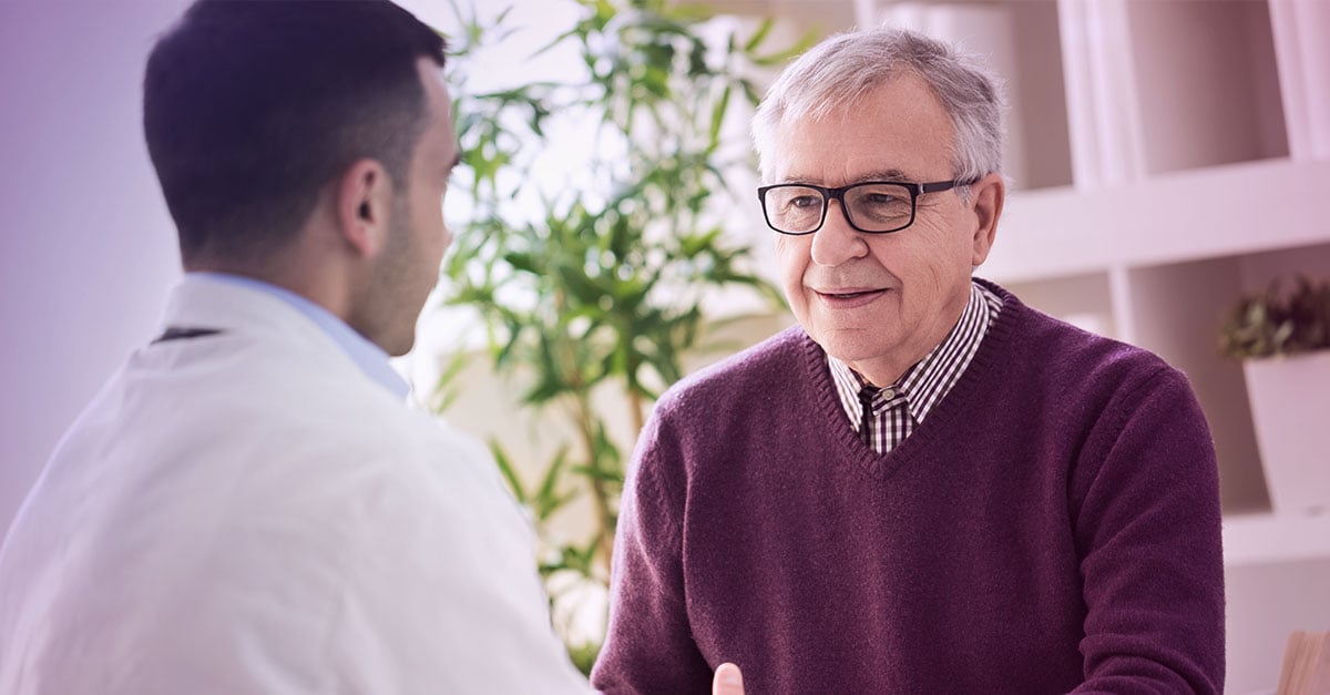 elderly man talking to doctor