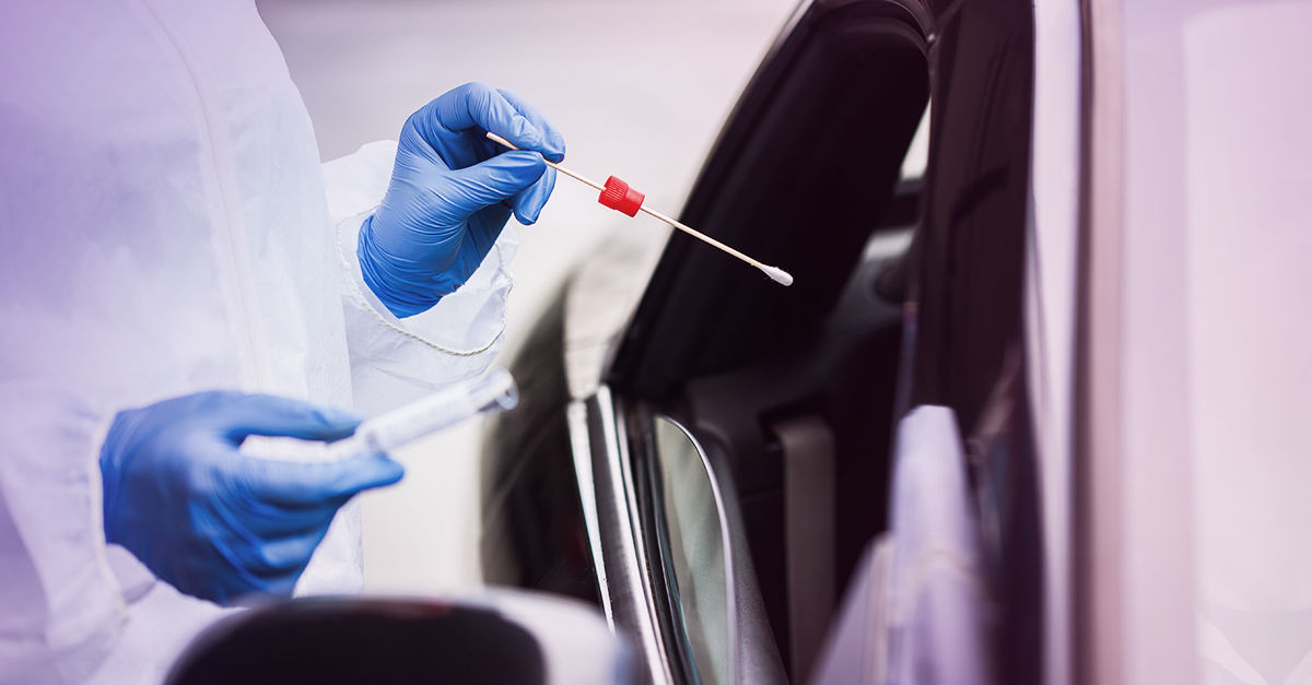 gloved hand preparing swab through car window